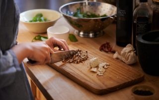 woman cutting nuts on a cutting board